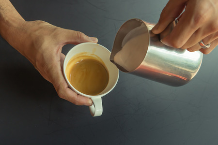 Pouring milk make latte art coffeeの写真素材