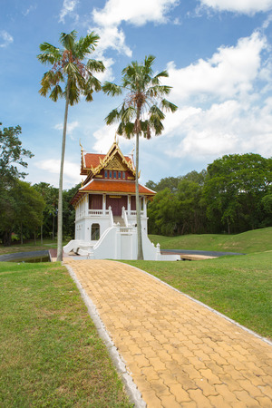Beautiful chapel of Buddha at middle pool and green grass all aroundの写真素材