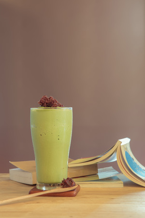 Green tea frappe with a book  at coffee shopの写真素材