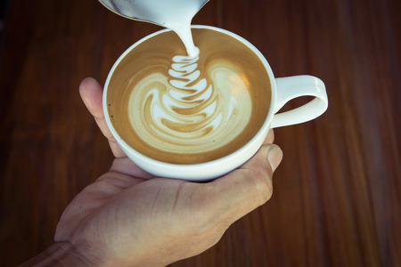 Pouring milk make latte art coffeeの写真素材