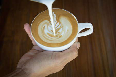 Pouring milk make latte art coffeeの写真素材