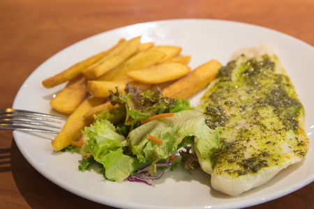 The sesoning fillet fish steak with potato friesの写真素材