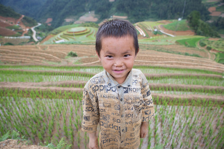 Mu Cang Chai , Vietnam - June 13, 2015 ; Ethnic children get-together on top a mountain while parents are working on the fields. Due to limited circumstance, he has to take care of himselves.のeditorial素材