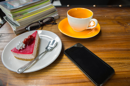 Cake and coffee  with accessories on table in coffee shopの写真素材