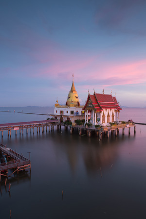 Beautiful sunset twilight at Temple in Thailand , unseen the chapel and pagoda in the seaの写真素材