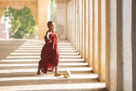 BAGAN, MYANMAR - DEC 13: Unidentified young Buddhism playing soccer at Shwezigon temple on Dec 13, 2015 in Bagan. Buddhism is predominantly of the Theravada tradition, practised by 89% of the population.のeditorial素材