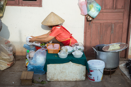 Vientiane , Laos - Jan 17 ; Women of vendor in Morning Market sell local food on January 17, 2016 .  Vientiane Laosのeditorial素材