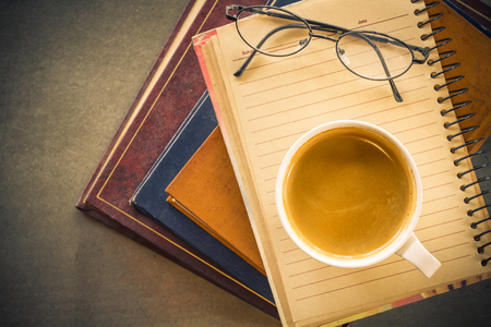 Reading vintage old book and coffeeの写真素材