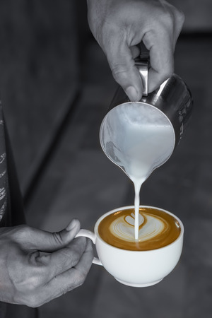 A cup of coffee with latte art , monochrome coverの写真素材