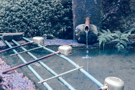 Ladles for hands cleaning at entrance to shrine of temple in Yamadera, Japan. retro picture styleの写真素材