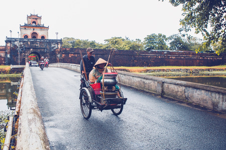 HUE, VIETNAM - NOVEMBER 06, 2016: Tricycle carry local food at the imperial gate in front of  Imperial Hue, Vietnamのeditorial素材