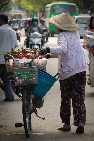 Steet vendor Vietnamese in Ho Chi Minh ,Vendor sell some fresh fruits on bicycleの写真素材