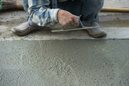 Plasterer concrete worker smooth the cementの写真素材
