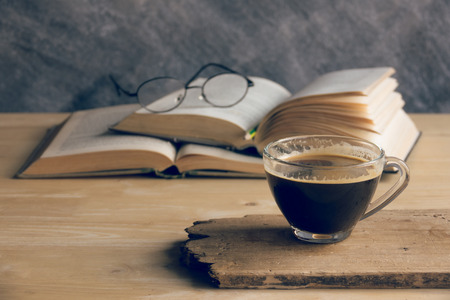 Cup of coffee with books on the tableの写真素材