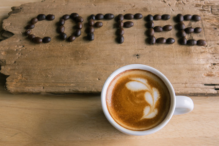 A cup of coffee with coffee wording form coffee beanの写真素材