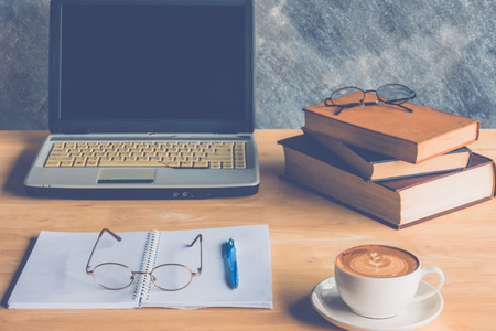 the office working place at morning. Coffee with laptop  glasses, notebook and  penの写真素材