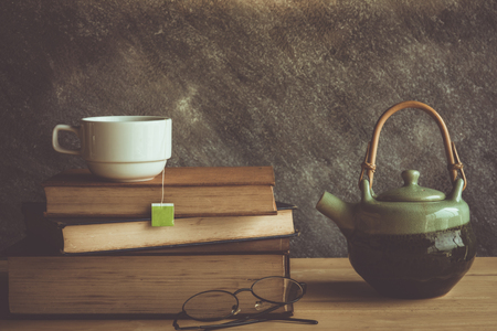 Cup of tea and book with classic glasses , retro color toneの写真素材