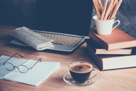 Black coffee with laptop and acessories  on wood tableの写真素材