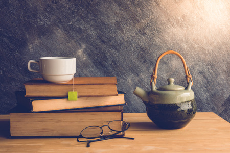 Cup of tea and book with classic glassesの写真素材