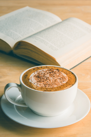 Cup of coffee with book in coffee shop vintage colorの写真素材