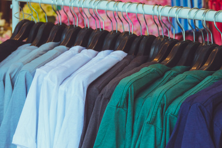 Selective focus Green fashionable clothing on hangers in shopの写真素材