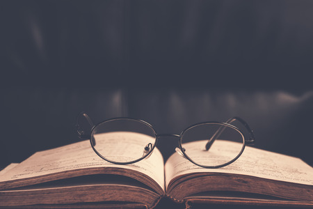 Closeup of reading glasses on the book.の写真素材