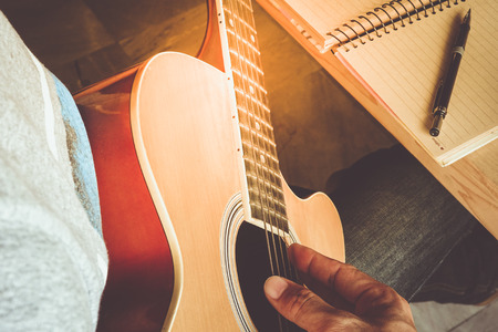 Man compose song and play guitarの写真素材