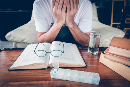 Education and health concept, hard study and reading might sick such as headacheの写真素材