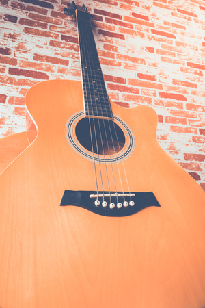 Acoustic guitar on wood tableの写真素材
