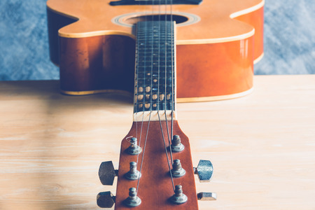 Acoustic guitar on wood table