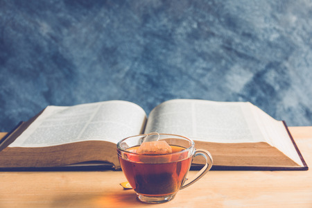 cup of tea and books on wooden tableの写真素材