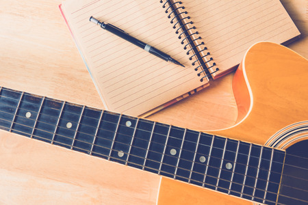 A paper for composion with guitar on wood tableの写真素材