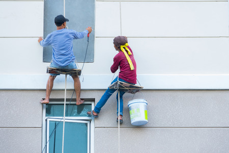 High workers hanging on the wallの写真素材