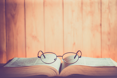 Book and Glasses with wood backgroundの写真素材