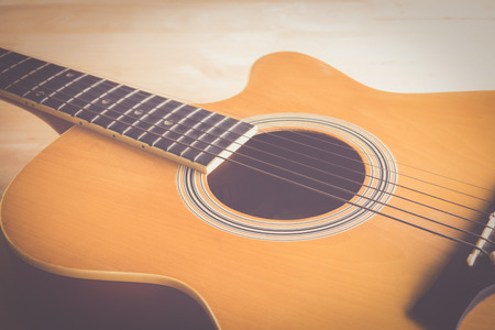 Acoustic guitar on wood tableの写真素材