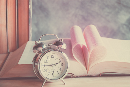 Heart book page with alarm clock in vintage effect styleの写真素材