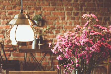 Vintage lighting and flower in coffee shopの写真素材