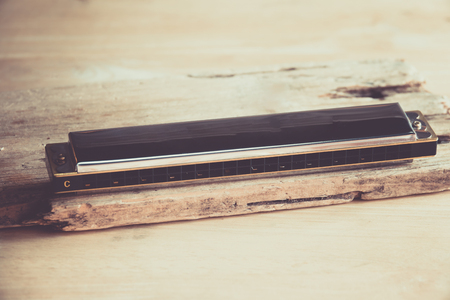 Closeup of mouthorgan on wooden background.の写真素材