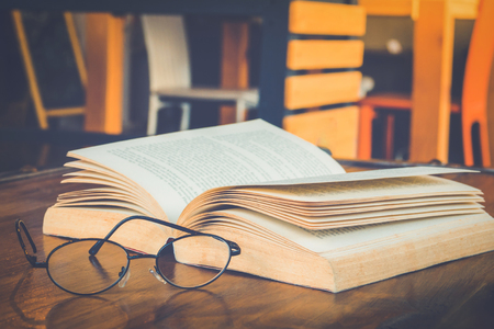 Book with glasses on table, vintage picture styleの写真素材