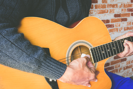 Close up a man playing guitarの写真素材