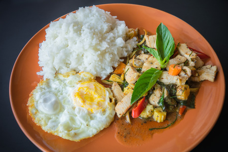 Thai spicy food, stir fried chicken whit basil on riceの写真素材