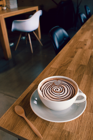 Hot chocolate on wood bar in cafeの写真素材