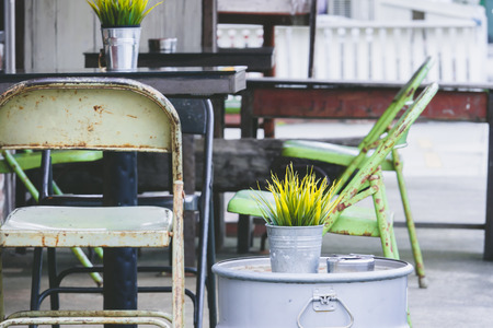Outdoor seating plant in pot with chair and tableの写真素材