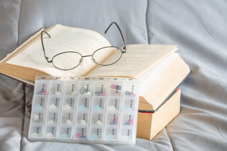 Pills box for week and separate the time with medicine in plastic box on tableの写真素材