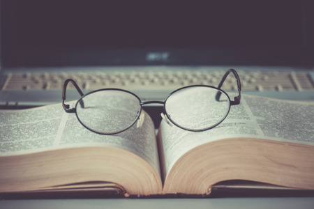 Closeup of reading glasses on the book.の写真素材