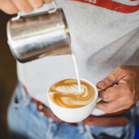 Making coffee latte art  by Barista in coffee shopの写真素材