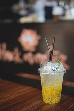 Passion fruist juice with soda in plasstic glass at coffee shopの写真素材