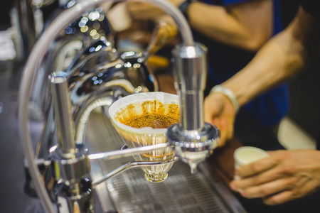Show brewing coffee drip with espresso machine by baristaの写真素材