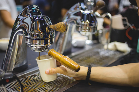 Close-up of espresso pouring from coffee machine. Professional coffee brewingの写真素材