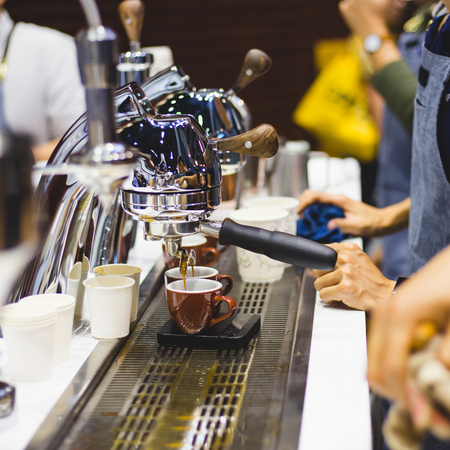 Close-up of espresso pouring from coffee machine. Professional coffee brewingの写真素材